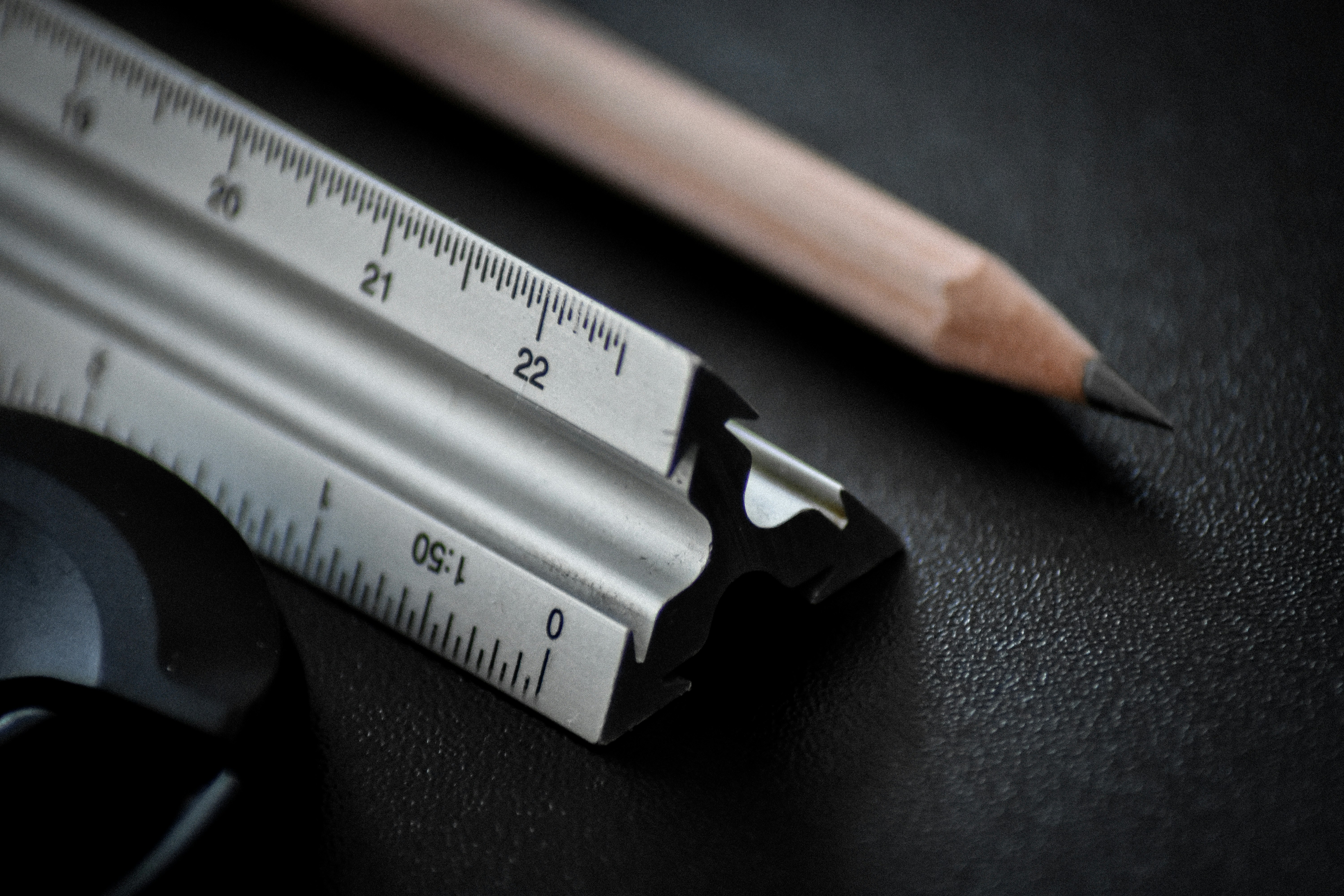 Architect blueprints with ruler and pencil showing precise measurement detail for construction estimate