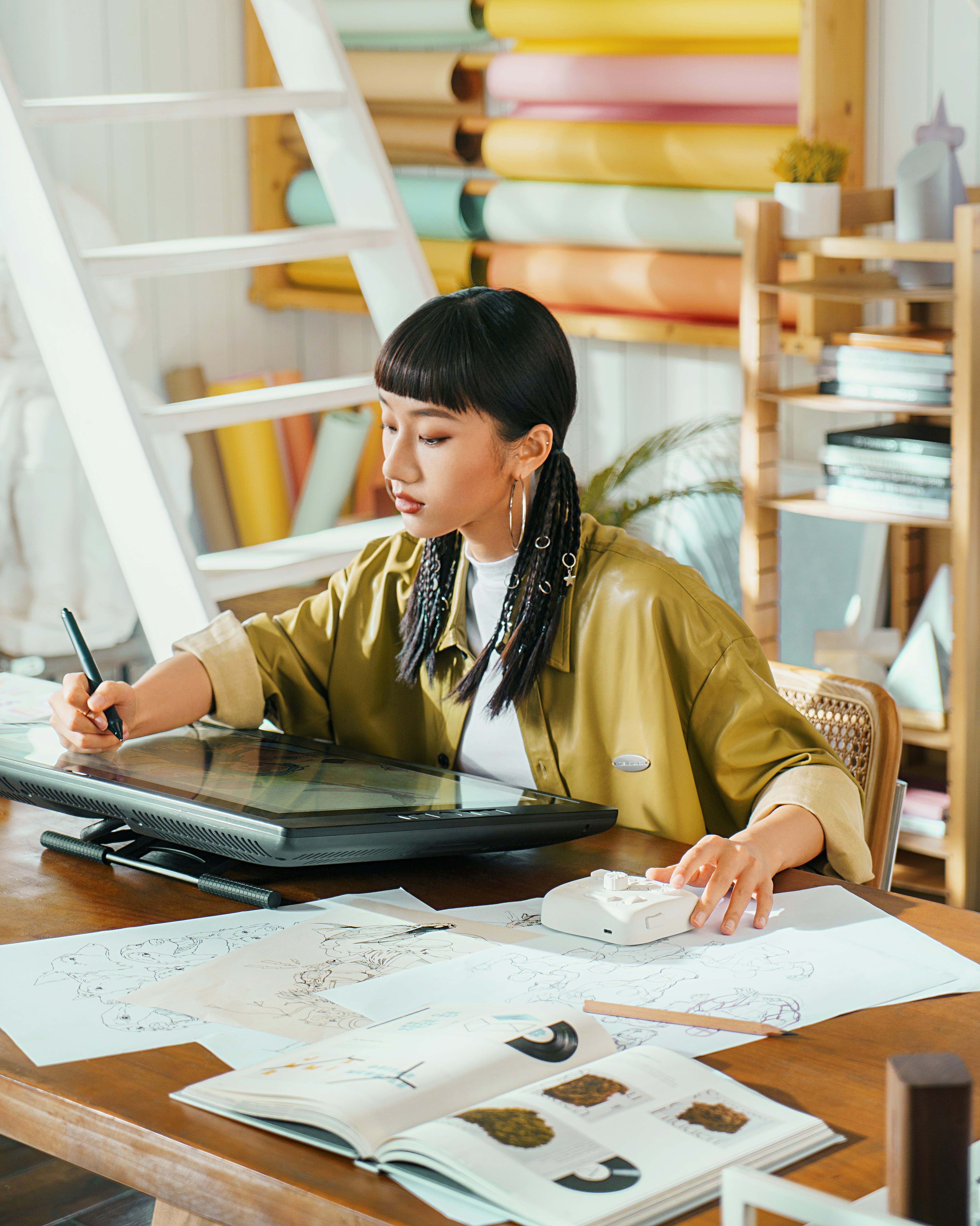 Graphic designer working on creative project at organized workspace with laptop and design tools