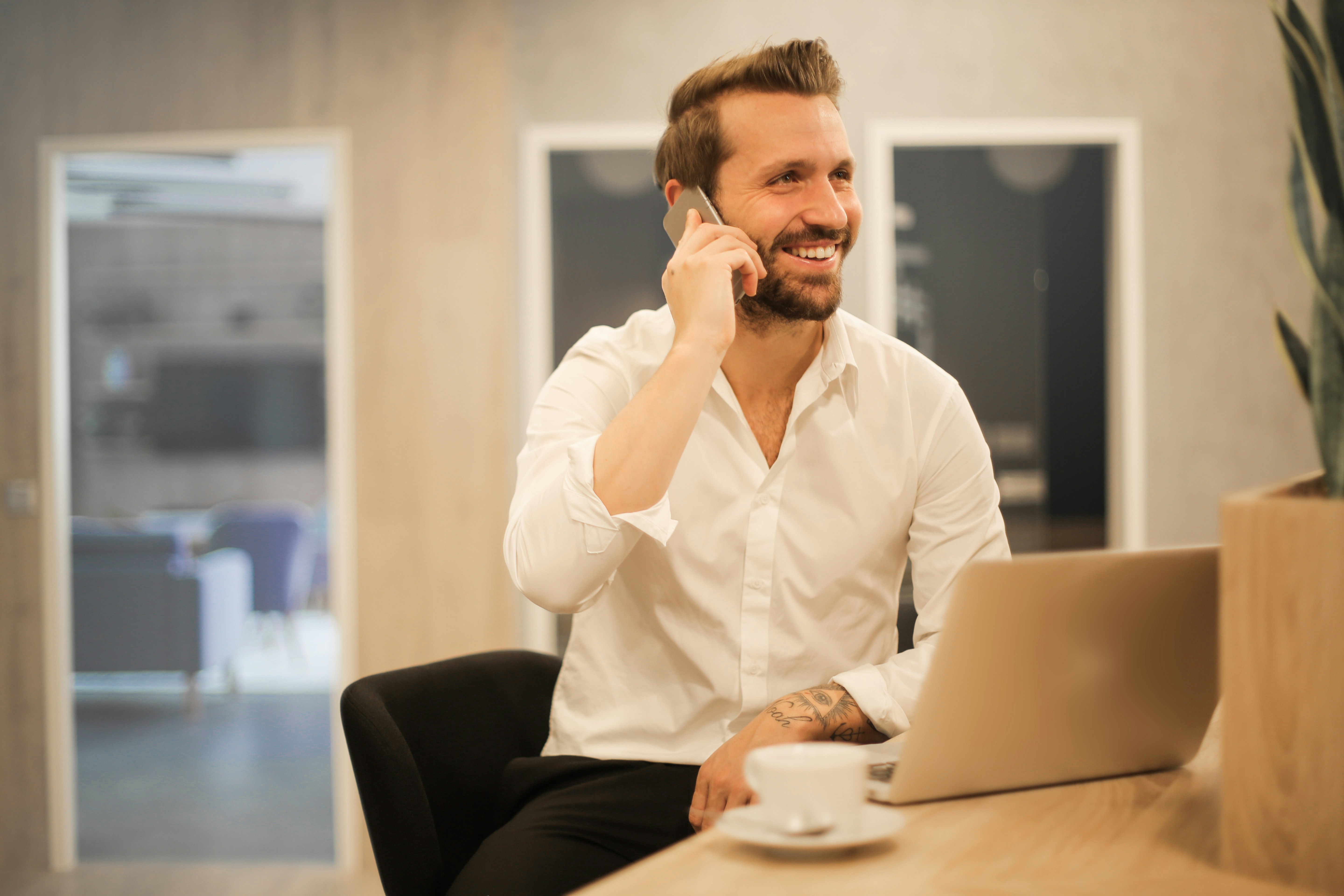 Professional service provider working on estimate at modern desk with laptop and documents