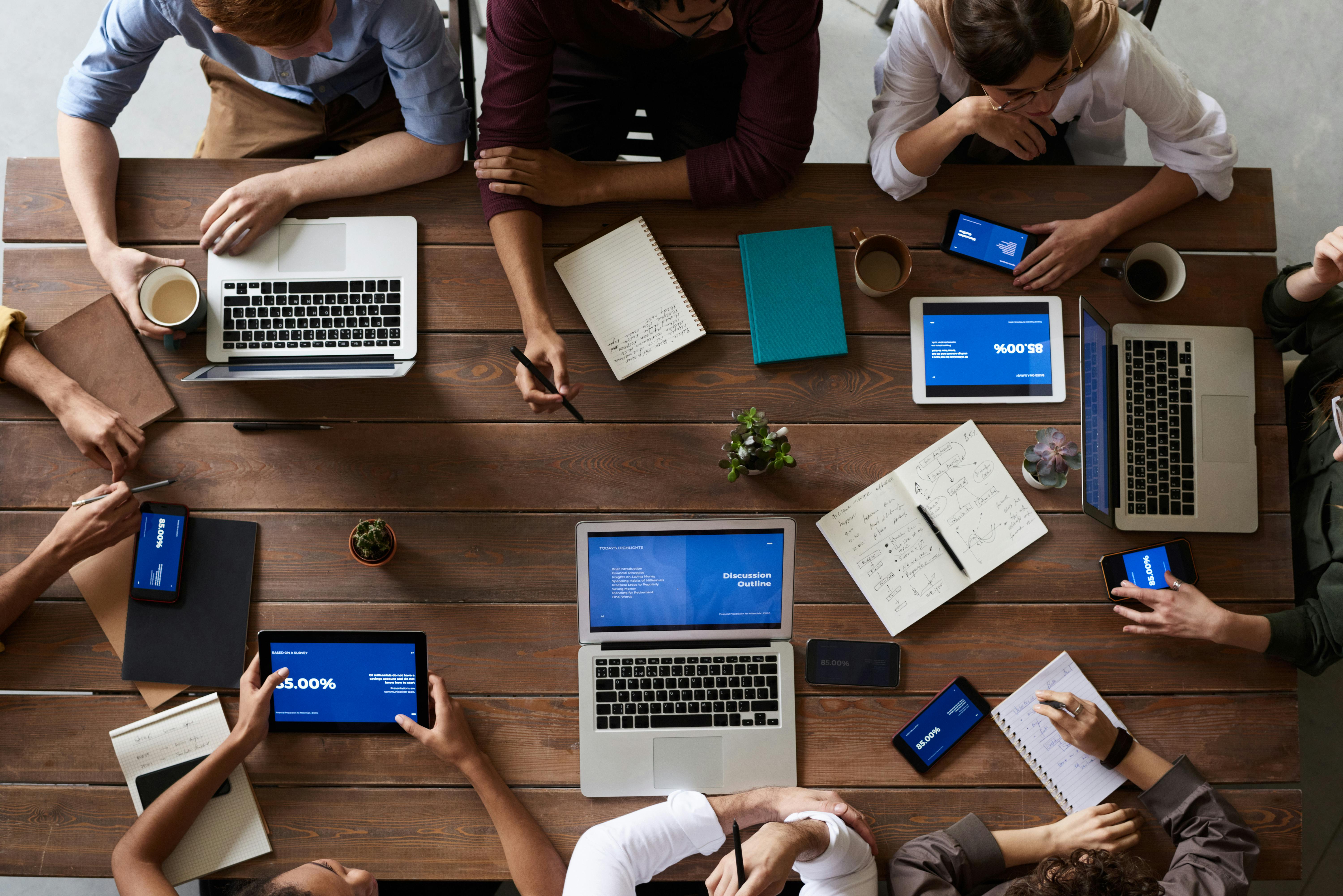 Law firm team meeting with laptops and documents