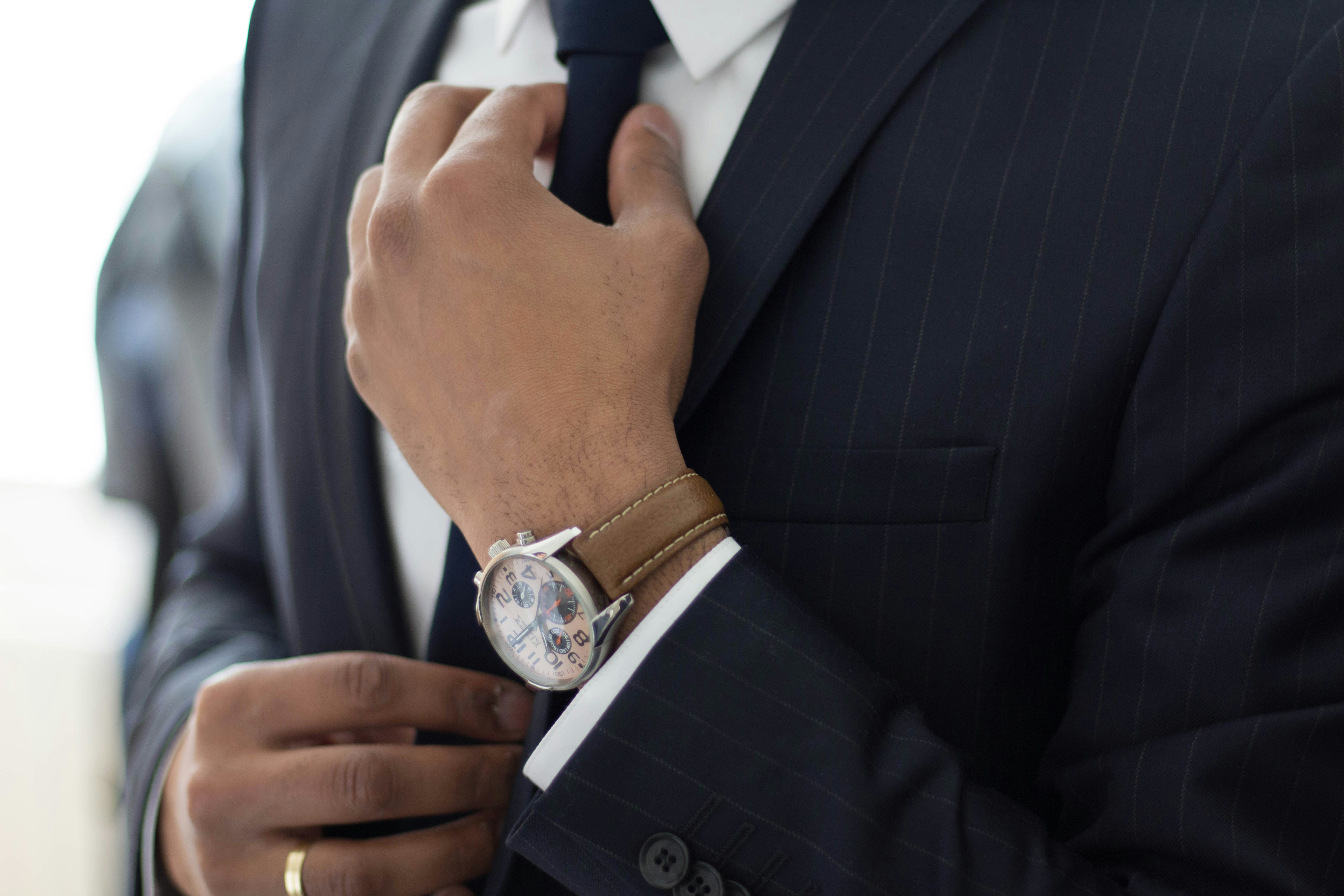 Professional man in suit straightening tie